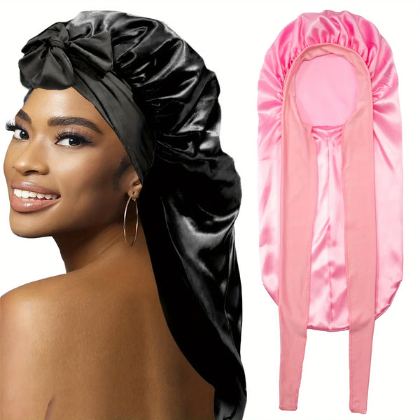 A black satin sleep bonnet and a pink satin hair wrap are shown side by side.