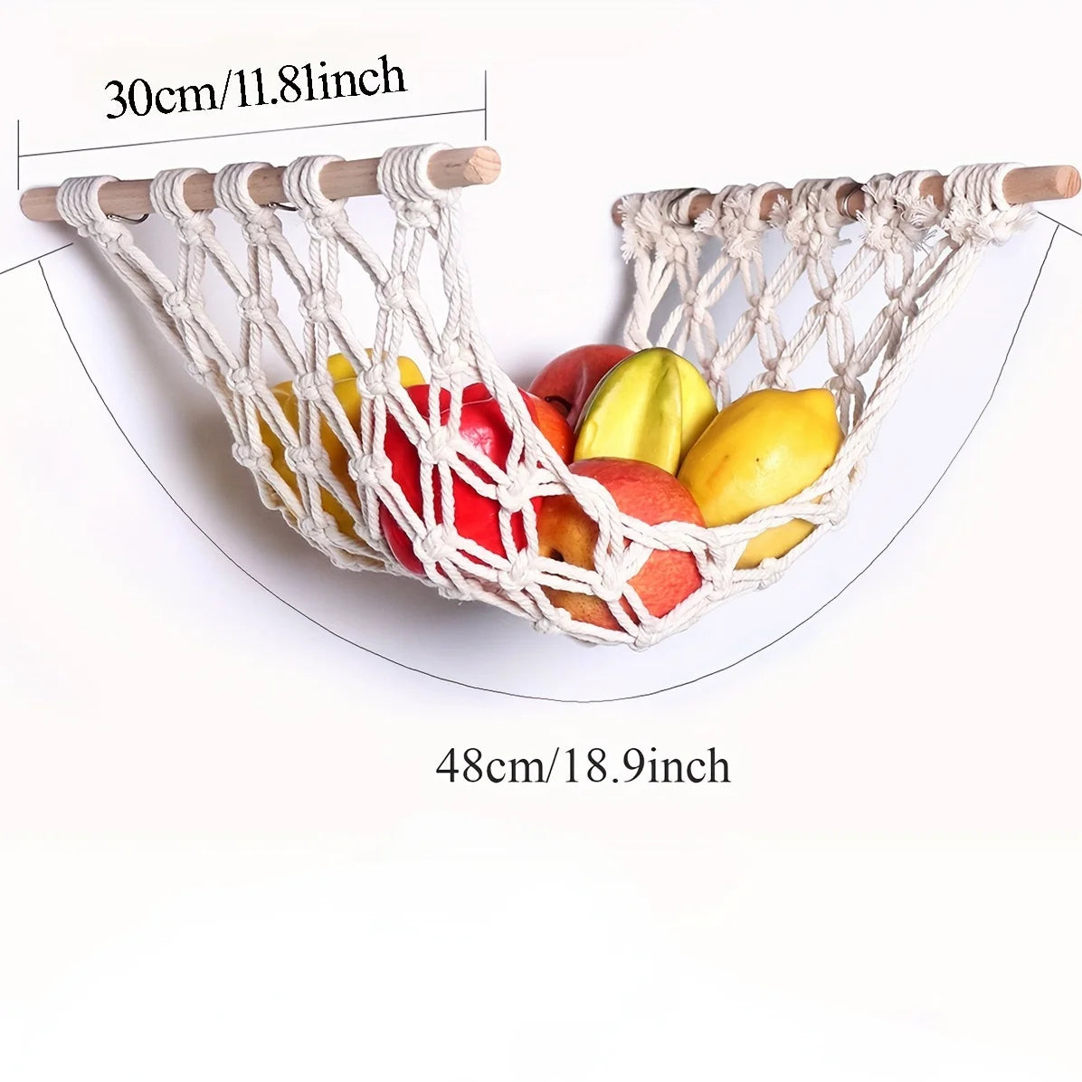 A woven sisal fruit hammock storage basket holding various colorful fruits.