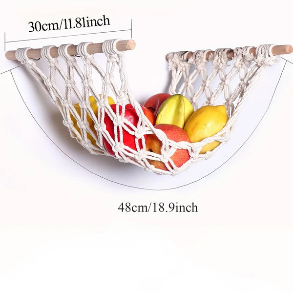 A woven sisal fruit hammock storage basket holding various colorful fruits.