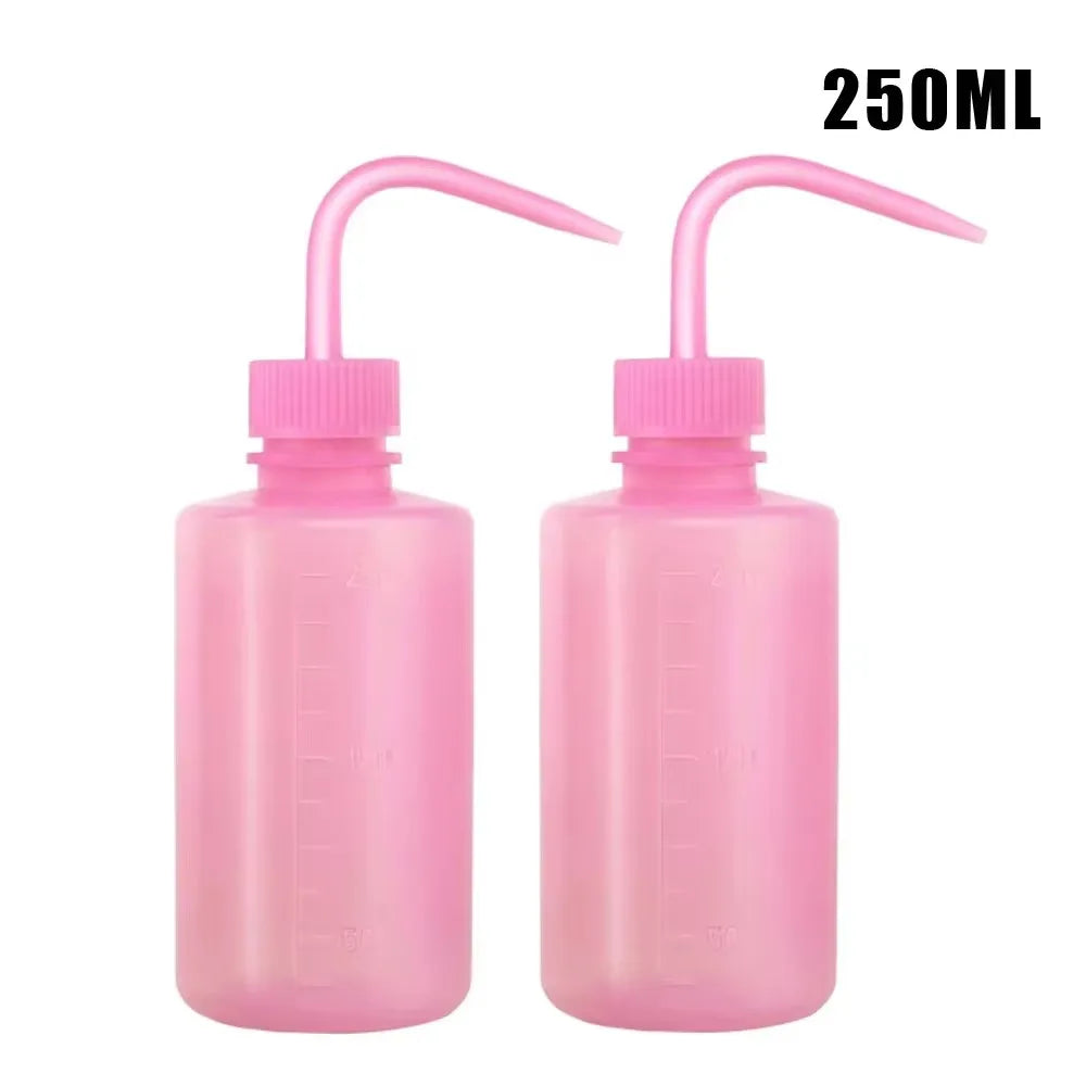A 2-pack of pink squeeze bottles with measurement marks for tattoo solutions.