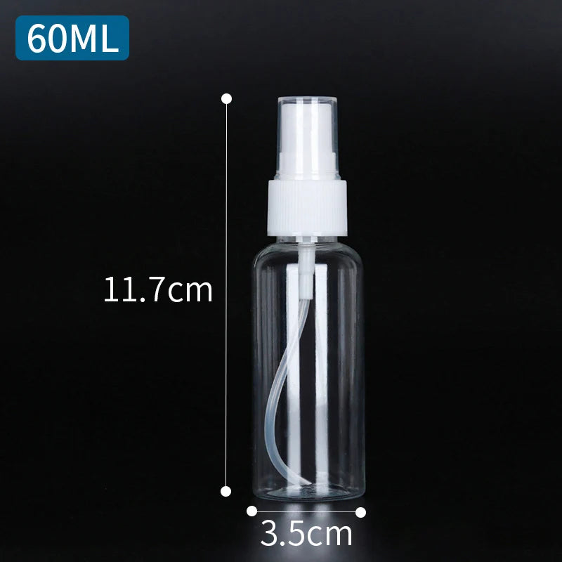 A clear glass refillable portable spray bottle with a white pump dispenser and volume markings.