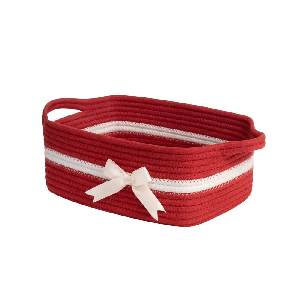 A woven cotton rope storage basket in red with white stripes and a white bow.