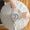 A hand is holding a white durable protective cover for an electric fan.