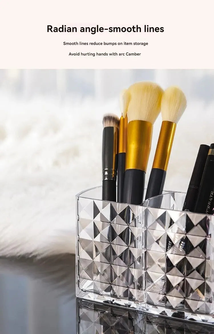 Clear acrylic makeup brush holder with three compartments displaying various makeup brushes.