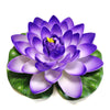 A vibrant purple artificial lotus flower with green leaves.