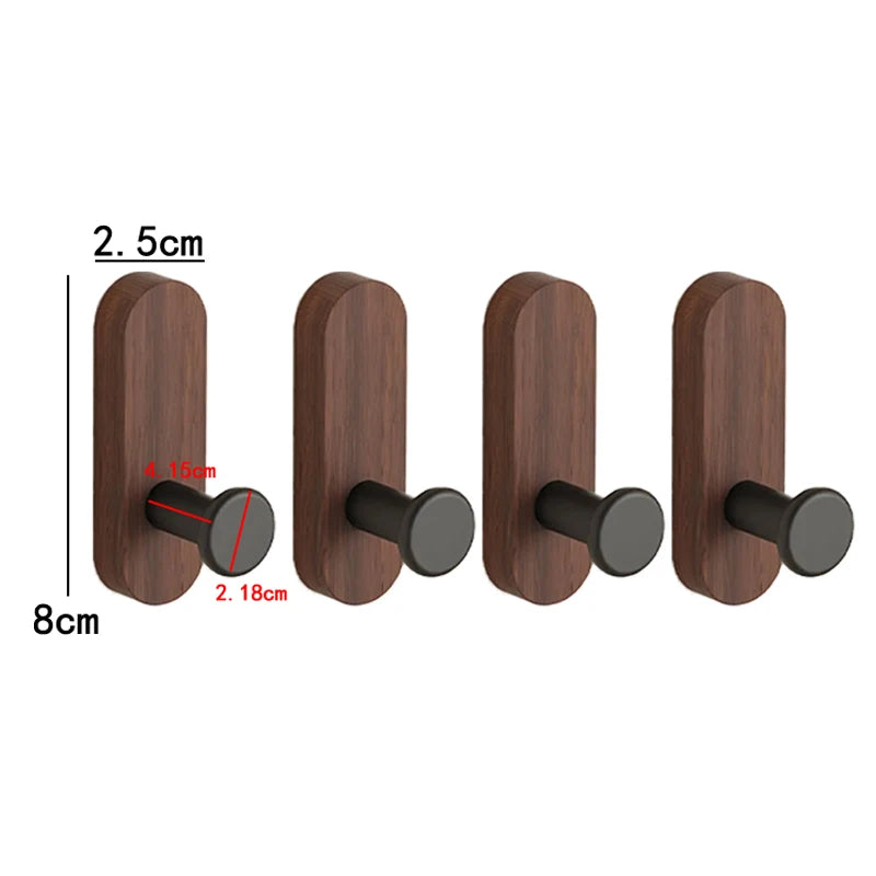 A set of dark brown walnut wood wall hooks with round black mounting pieces.