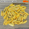A pile of small, elongated, golden sunflower seeds for decoration.