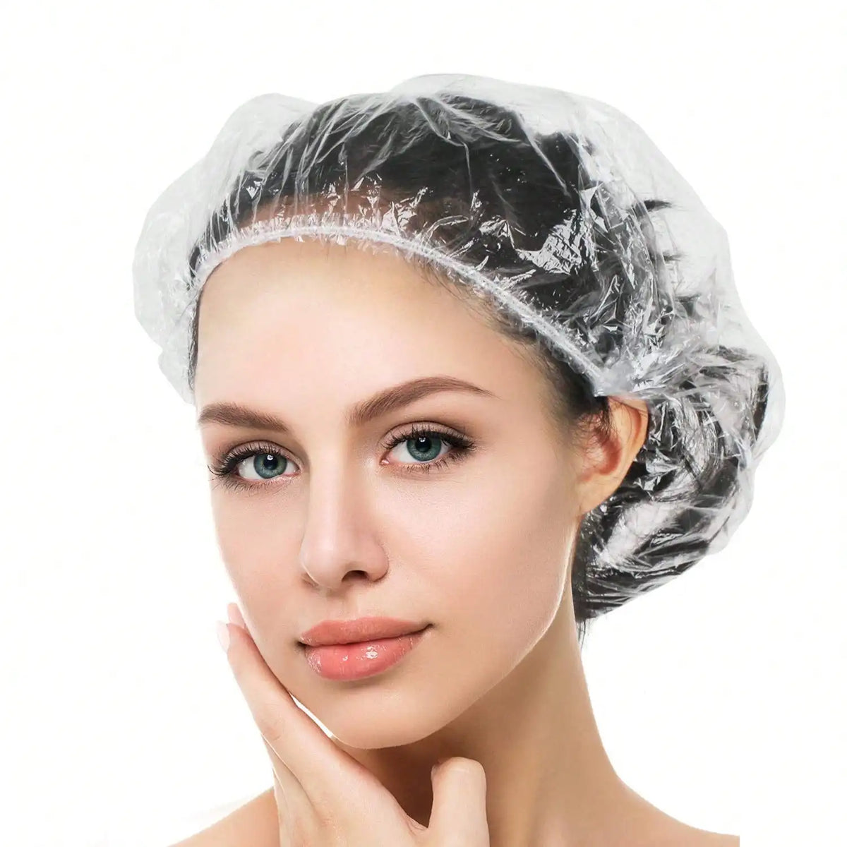 A woman wearing a disposable transparent shower cap, looking directly at the camera.