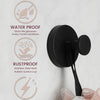 A black stainless steel suction cup towel rack with a flexible cord, shown against a light background.