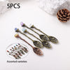 Five assorted natural crystal spoons with various colors and textures displayed on a white background.