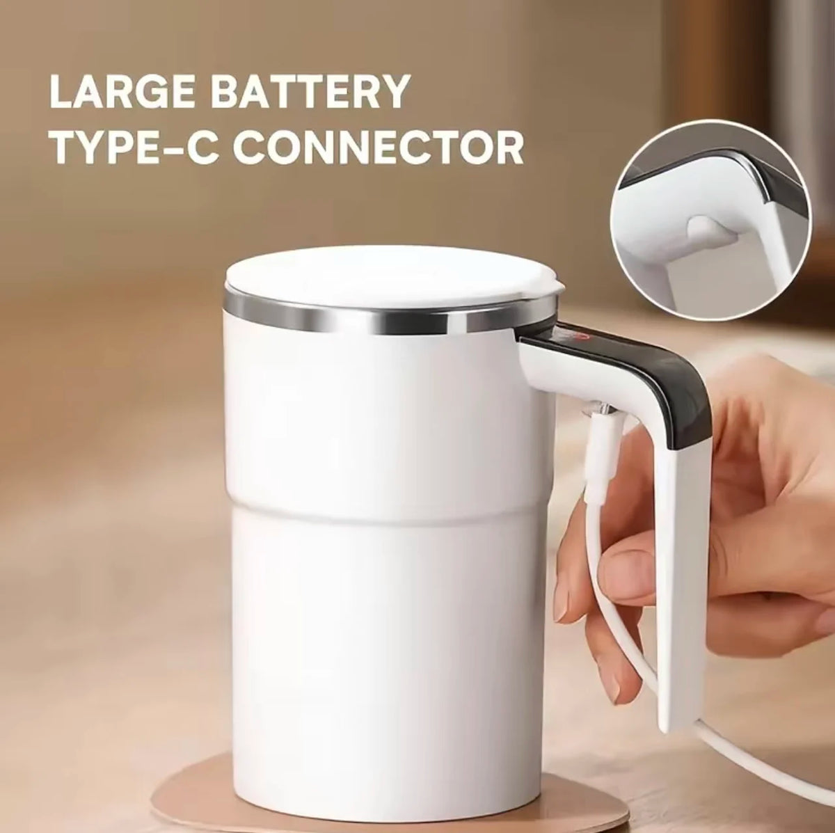 A white electric self-stirring coffee mug with a large Type-C connector is shown being held by a hand.