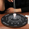 A silver chain necklace with a clear crystal pendant is displayed above a wooden divination altar featuring symbols and text.