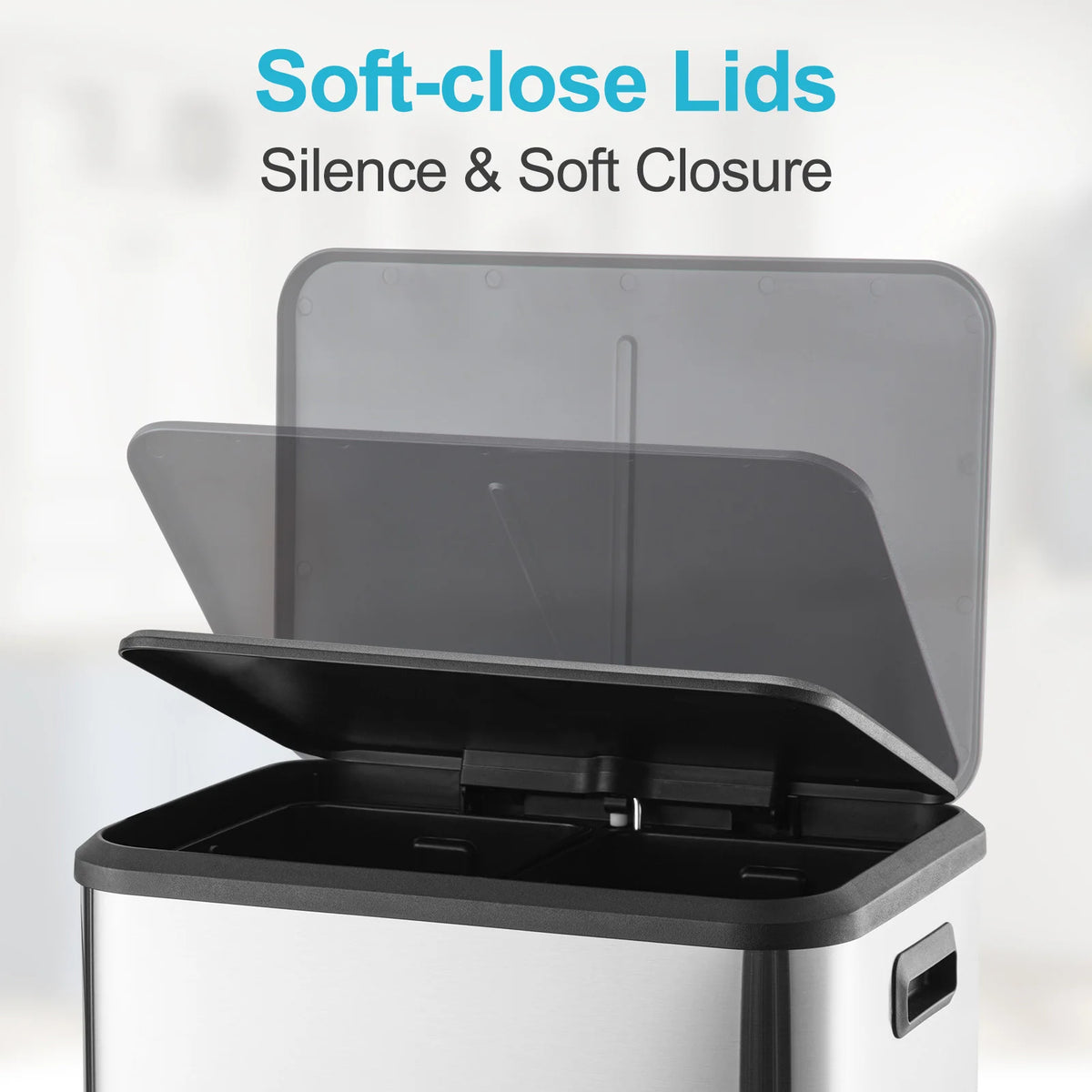 A close-up of a stainless steel trash can with soft-close lids open, showing the dual compartment design.
