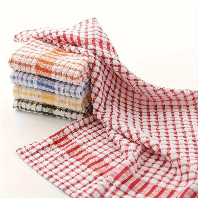 A stack of absorbent cotton cleaning cloths in various plaid patterns, including red and white.
