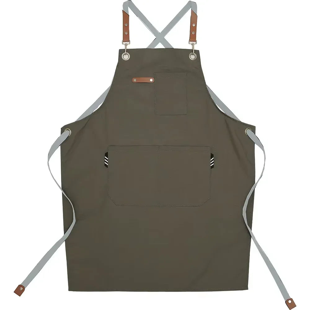 A dark olive green adjustable hairdressing apron with straps and pockets.