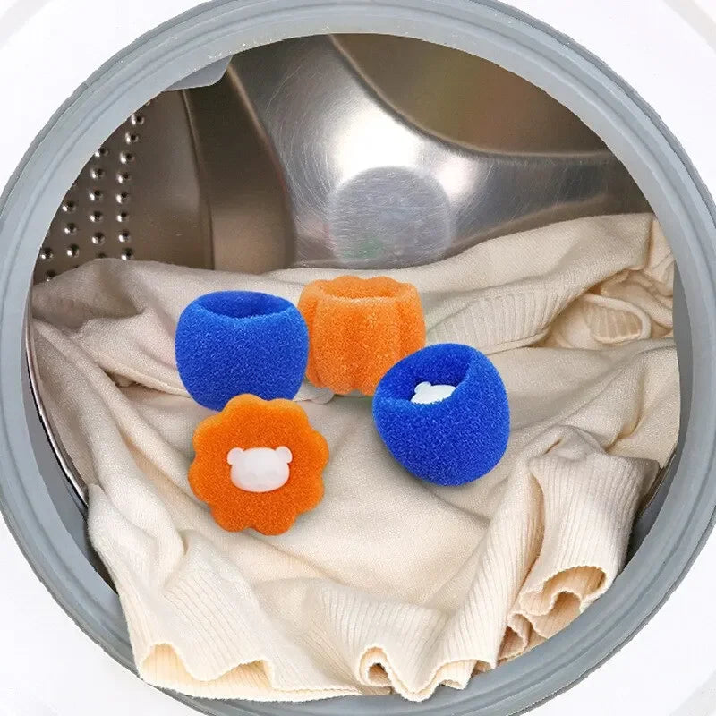 Several colorful laundry balls in blue and orange are placed on a beige cloth inside a laundry basket.