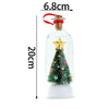 A clear glass bottle with a cork stopper and a gold star decoration, used as a Christmas message bottle.