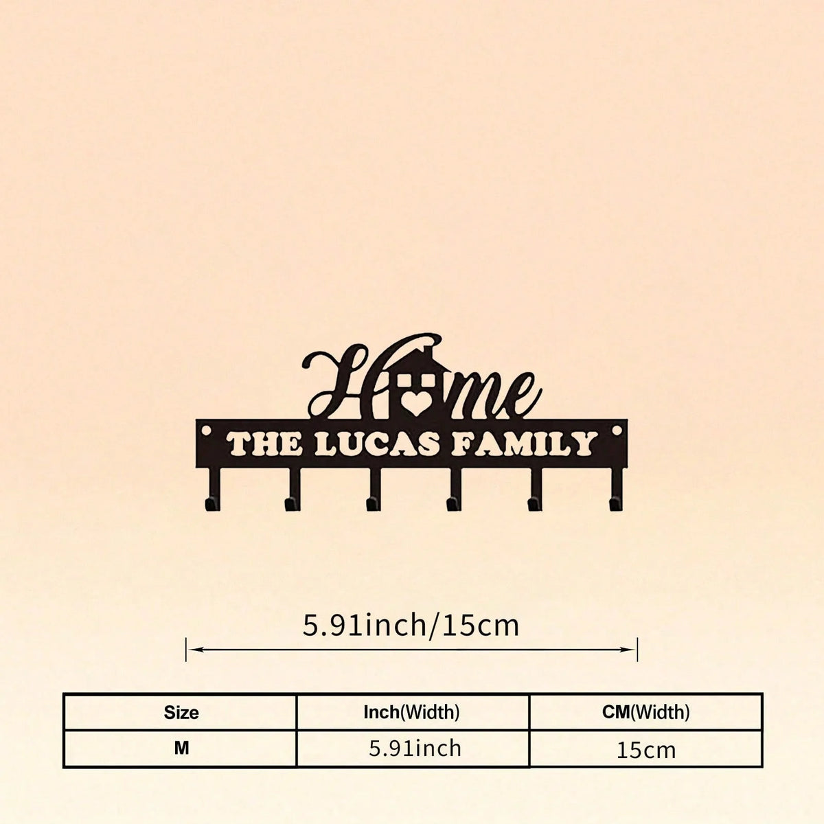 A black silhouette design featuring the words Home The Lucas Family on a metal wall hook key holder.