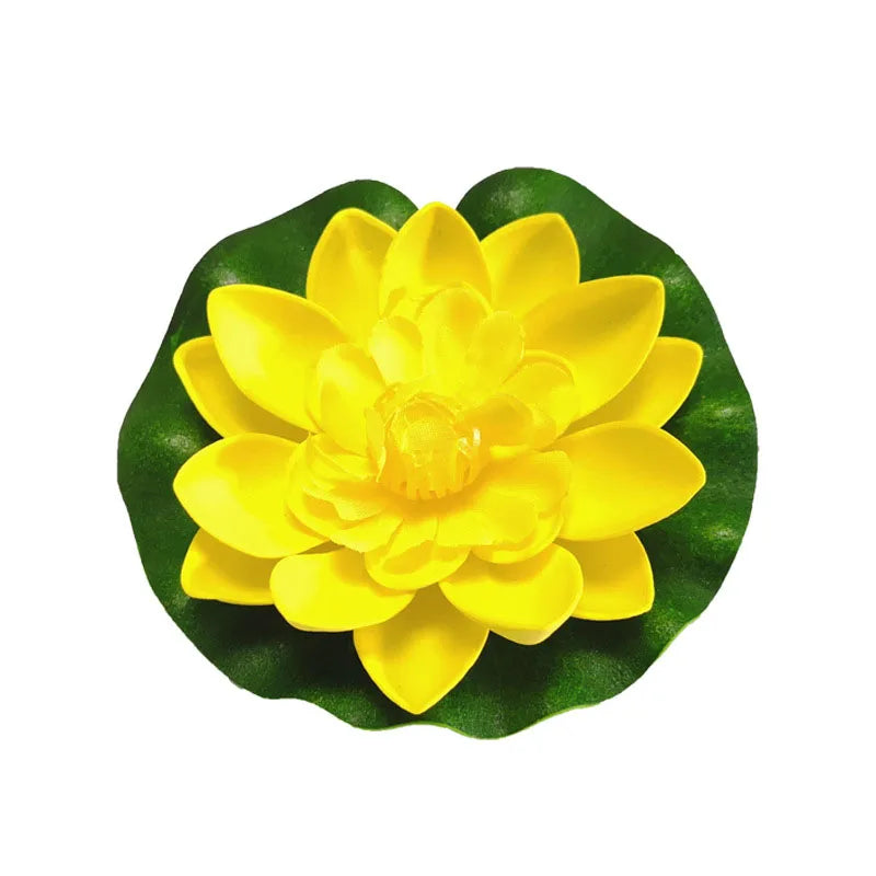 A bright yellow artificial lotus flower with green leaves for pond and garden decor.