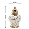 A golden ceramic flower vase with a textured, faceted design and a lid.