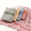 A stack of colorful absorbent cotton cleaning cloths featuring plaid patterns in green, yellow, blue, and red.