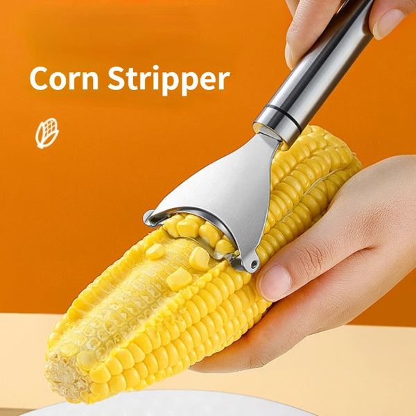 A hand is using a stainless steel corn stripper tool to remove kernels from a corn cob.