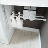 White adjustable telescopic curtain rods mounted under a cabinet