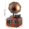 A retro phonograph music box decor featuring a bronze-colored horn and a wooden base.