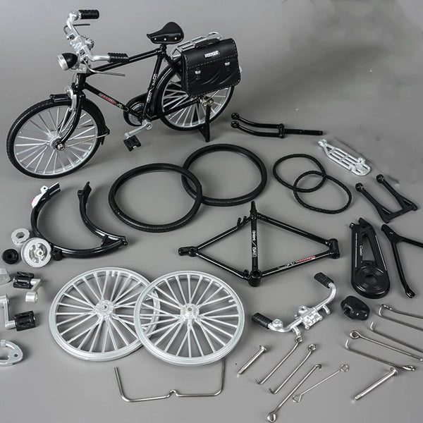 A collection of parts and a finished retro style DIY bicycle model including wheels, frame components, and accessories.