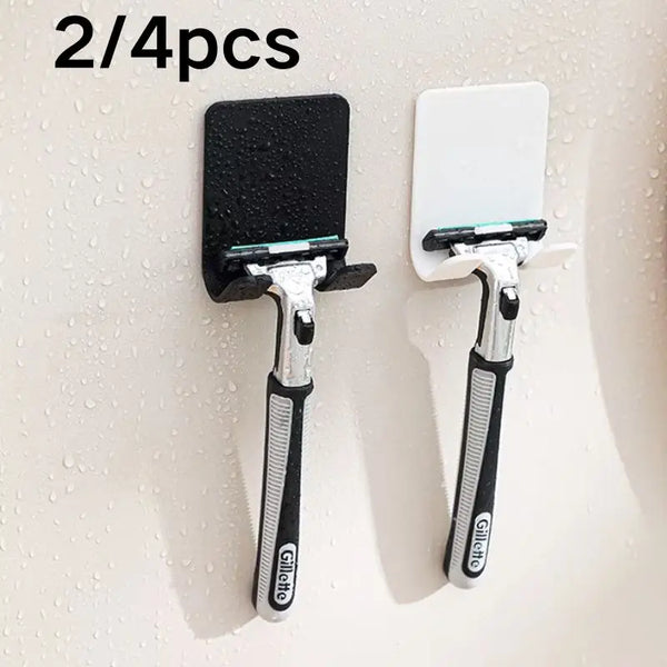 Two black and white Gillette razor holders mounted on a wall.
