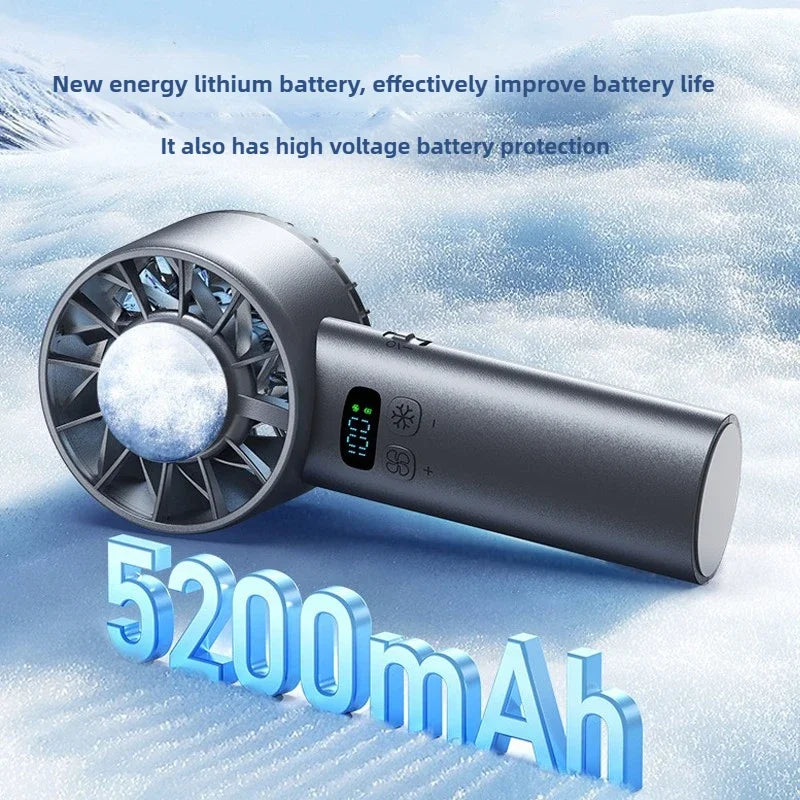 A silver ice compress fan with a battery, shown against a snowy background.
