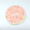 A pink citrus fruit slice design on a white background for a reusable fruit shower cap.