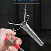 A hand is using a spring pipe grappling hook tool to clear a drain or sink blockage.