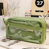 A lime green transparent pencil pouch is displayed on a white surface next to other stationery items.