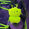 A bright lime green plush cat keychain is attached to a black strap and a purple disc.