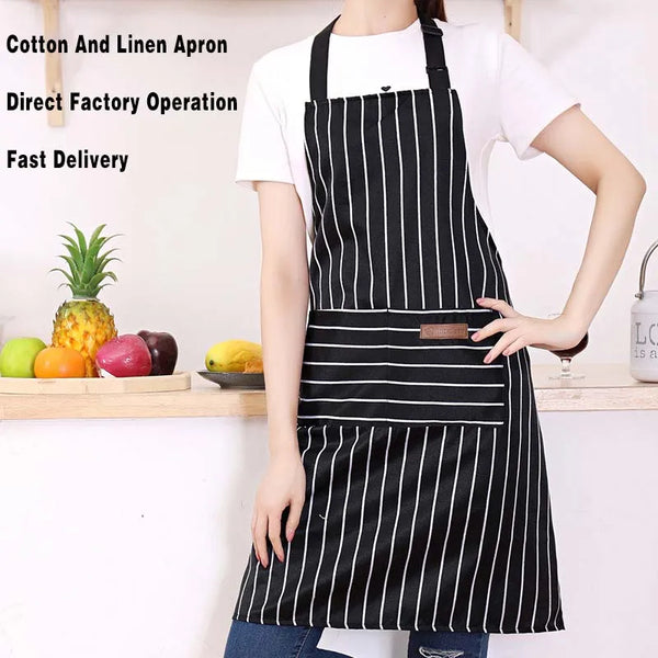 A woman wearing a black and white striped cotton and linen apron with pockets, standing in a kitchen setting.