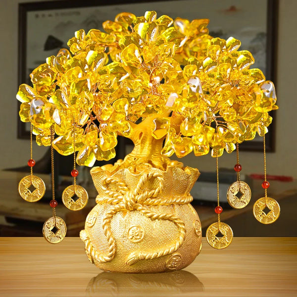 Golden crystal prosperity tree with hanging golden charms displayed on a wooden surface.