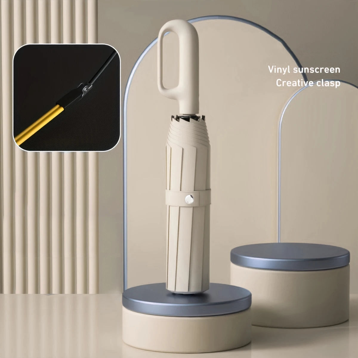 A silver vinyl sunscreen creative clasp on a folding umbrella handle displayed against a light background.