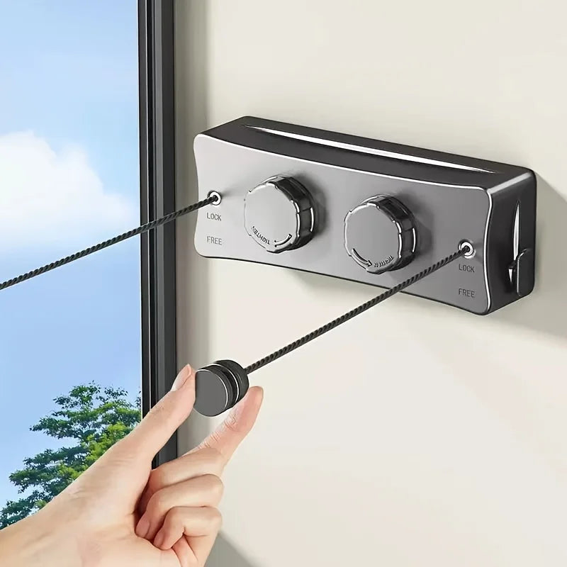 A hand is pulling a black cord from an adjustable stainless steel drying rope lock mechanism mounted on a wall.