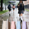 A set of five compact 5-fold travel umbrellas in various pastel colors displayed on a light surface.