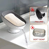 A suction cup soap dish with built-in drainage is shown dispensing soft soap into a sink.