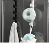 A white door hook rack with a spherical, light blue sponge attached, used for multi-purpose home supplies storage.