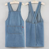 A pair of denim overalls or apron displayed on a hanger.