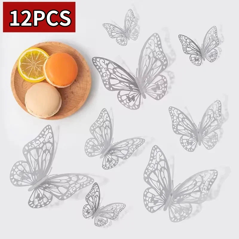 Twelve gray decorative butterfly wall stickers and a slice of orange fruit on a wooden surface.