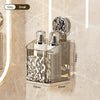 Stainless steel suction cup storage rack with glass bottles and a brush on a bathroom surface