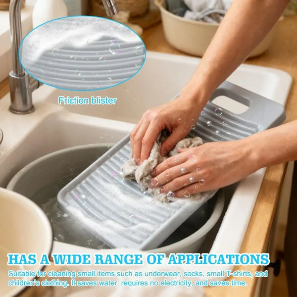 A hand is using a silicone fabric washing board to clean items in a sink.