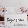 A white box labeled Dryer Sheets with a sheet of dryer sheets inside on a marble surface.