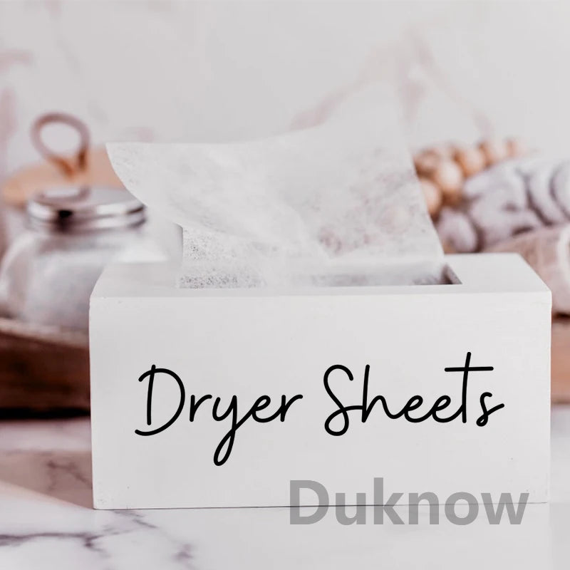 A white box labeled Dryer Sheets with a sheet of dryer sheets inside on a marble surface.