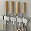 Wall mounted broom holders with wooden handles and chrome shafts for kitchen or bathroom