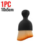 A black multi-surface cleaning brush with a yellow-orange bristles shown against a white background.